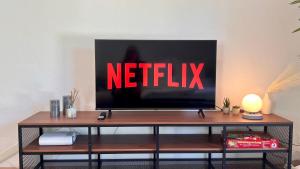 a television on a table with the netflix sign on it at Stilvolles Apartment im Siebengebirge in Königswinter +19 photos