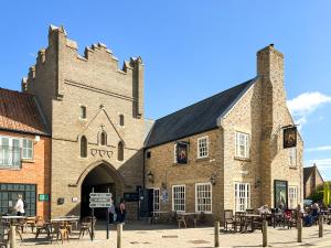 a large building with tables and chairs in front of it at Solara Breeze in Filey