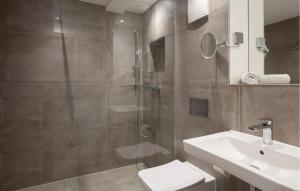 a bathroom with a shower and a toilet and a sink at Princess in Binz +29 photos
