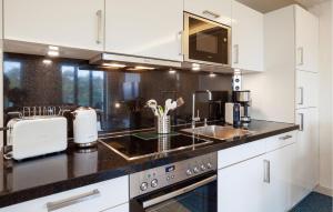 a kitchen with white cabinets and a sink at Princess in Binz