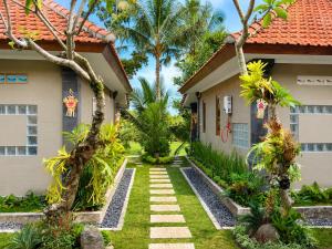 a house with a garden in front of it at Bendul Retreat in Tabanan