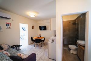 a room with a bed and a kitchen with a table at Zoe Apartment Port View Β in Rafina