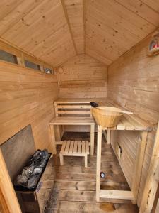 a wooden sauna with a bench and a table at Coast to Coast Accom - Shap in Shap