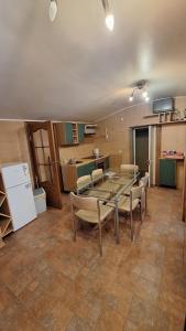 a dining room with a table and chairs and a refrigerator at Jūrmala beach in Jūrmala