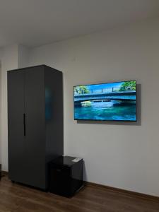 a black cabinet in a room with a picture on the wall at Ajazi Rooms in Struga