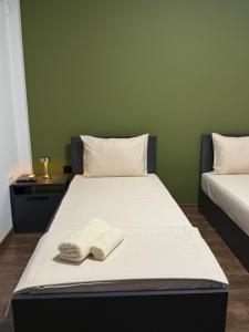 a bed with two towels on it in a room at Ajazi Rooms in Struga