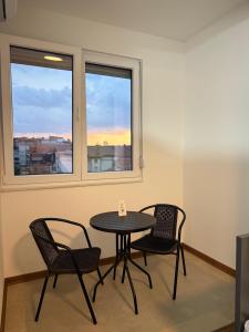 a table and chairs in a room with a window at Ajazi Rooms in Struga