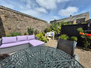 a patio with a table and a couch and a table at Coast to Coast Accom - Shap in Shap