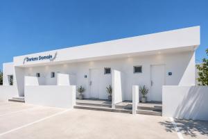 a white building with a sign on it at Dorians - Faliraki in Faliraki