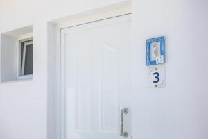 a white door with a number on it at Dorians - Faliraki in Faliraki
