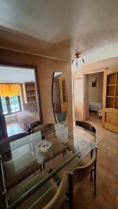 a dining room with a glass table and a bedroom at Jūrmala beach in Jūrmala +9 photos
