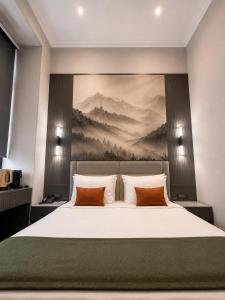 a bedroom with a bed with a painting on the wall at Amara Boutique in Baku