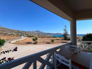 a balcony with a table and a view of the ocean at Kofini Falassarna in Falasarna