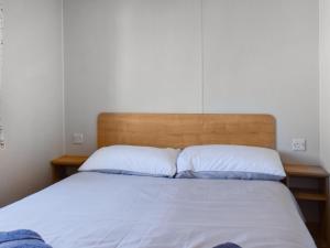 a bedroom with a bed with two pillows at The Hideaway - Uk49292 in Morecambe
