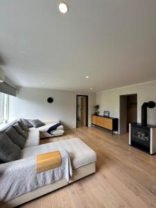 a living room with a couch and a table at Laitselossi tee Apartment in Laitse