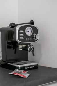 a cellphone is on top of a coffee machine at Dorians - Faliraki in Faliraki +16 photos
