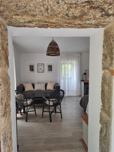 a living room with a couch and chairs at Entrerobles - Casiña Cereixa in La Cañiza