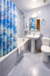a bathroom with a sink toilet and a shower curtain at Hotel Latif Samarkand in Samarkand +99 photos