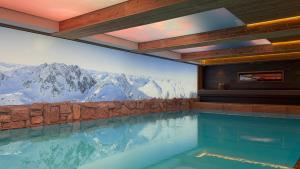 a swimming pool with a view of the mountains at Sporthotel St. Anton in Sankt Anton am Arlberg