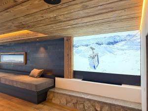a room with a large window with a view of mountains at Sporthotel St. Anton in Sankt Anton am Arlberg
