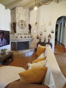 a living room with a couch and a fireplace at Gal House in Bali +16 photos