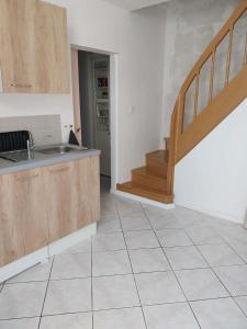 a kitchen with a sink and a staircase at Lumières de Tuffeau in Château-du-Loir +8 photos