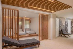 a living room with two beds and a chair at Villapark Vargesztes in Várgesztes +28 photos