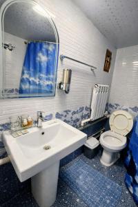 a bathroom with a white sink and a toilet at Hotel Chorminor 110 m to Old Town GET EARLY CHECK IN AND CHECK OUT in Bukhara +28 photos