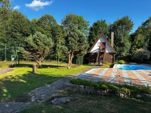a barn in the middle of a park with a yard at Goralské chalupy in Zálesie