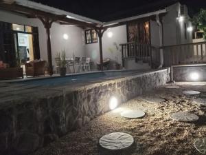 a house with a stone wall at night at L'instant Varangue in Albion