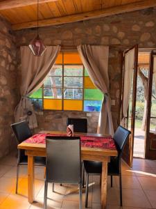 a dining room with a wooden table and chairs at Vayu- en La Casa de Nanda in San Javier