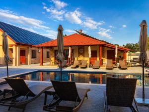 a group of chairs and umbrellas next to a pool at Bereg-Travel in Berehove