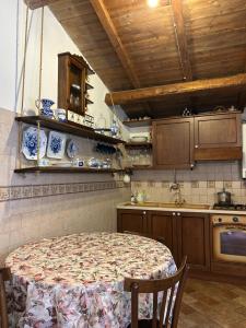 a kitchen with a table and a kitchen with blue and white dishes at Nido Stellato in Calascio +5 photos