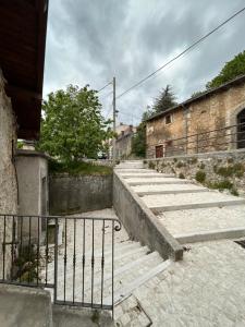a set of stairs in an old building with a gate at Nido Stellato in Calascio