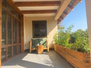 a porch with a bench and a window at Osinoni Cottages in Isiolo