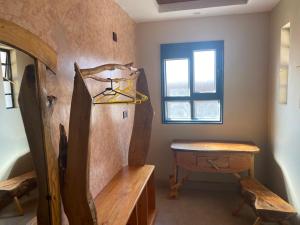 a room with a wooden table and a window at Osinoni Cottages in Isiolo