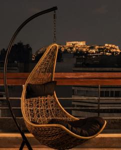 a rattan hammock hanging from a pole at Athens Odeon Hotel in Athens