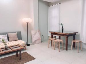 a living room with a table and a couch at 1BR Apartment Beach Getaway Perfect for Couples in Bangcusay +14 photos