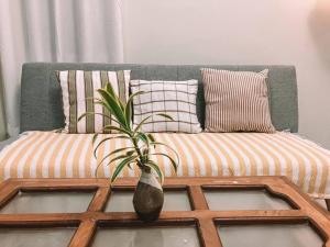 a vase sitting on a coffee table with a couch at 1BR Apartment Beach Getaway Perfect for Couples in Bangcusay
