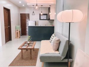 a living room with a couch and a table at 1BR Apartment Beach Getaway Perfect for Couples in Bangcusay
