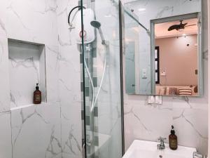a bathroom with a shower and a sink at 1BR Apartment Beach Getaway Perfect for Couples in Bangcusay