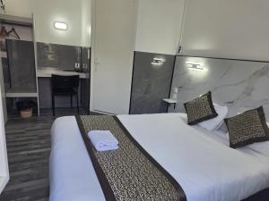 a hotel room with a large bed and a desk at Fasthotel Tours Nord in Parçay-Meslay