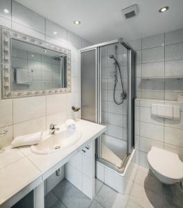 a bathroom with a shower and a sink and a toilet at Apart Waldblick in Serfaus +22 photos