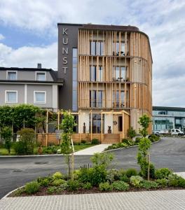 a rendering of a building with a wooden facade at Hotel KUNST in Krško