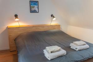 a bedroom with a bed with two towels on it at Le grand bleu, 300m de la mer et centre ville in Étretat