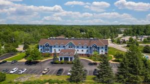 an aerial view of a large house with a parking lot at Holiday Inn Express Biddeford by IHG in Biddeford