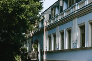 an exterior view of a blue building with windows at Meidan Heritage Suites Tbilisi in Tbilisi City