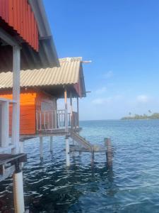 a house on the water with a dock in the water at Cabañas Wailidub, San Blas in Ogobsitupo +4 photos