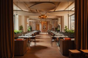 a row of tables and chairs in a restaurant at Aethos Hotel Milan in Milan