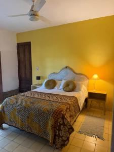 a bedroom with a bed with two pillows on it at Varuna- en La Casa de Nanda in San Javier